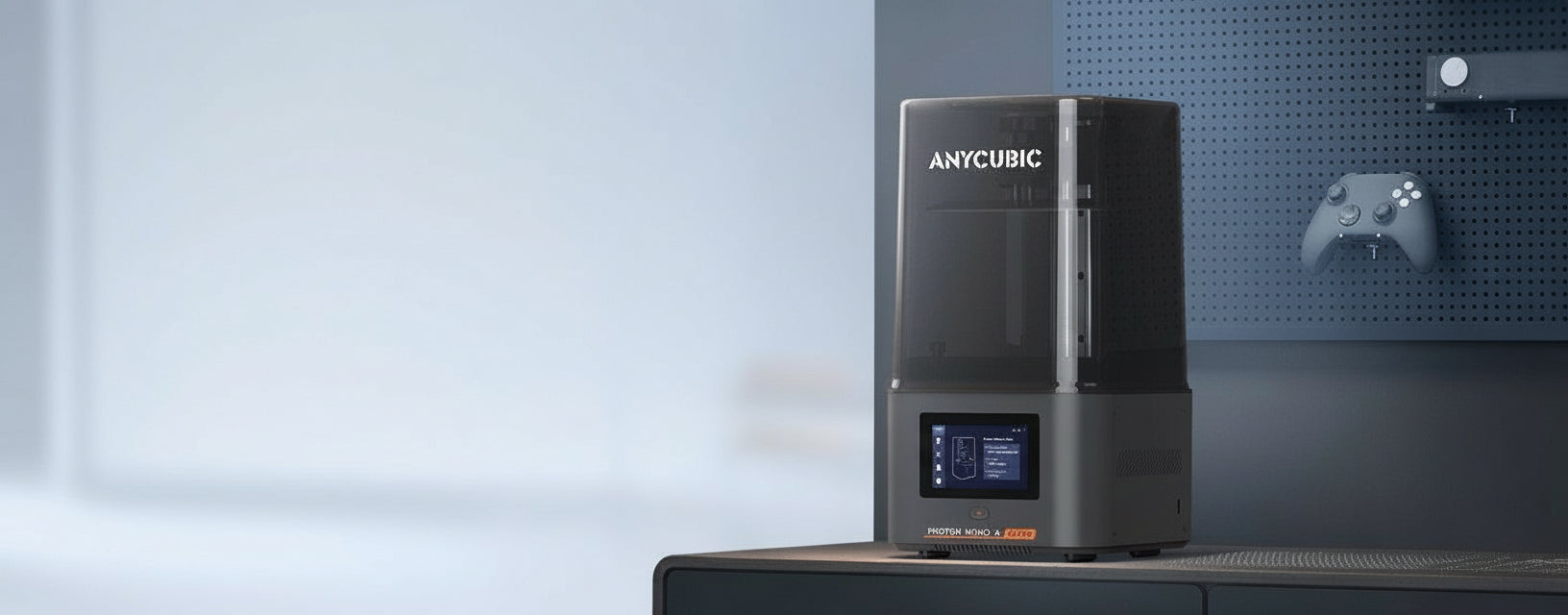 Anycubic 3D printer on a blurred background with branding and product features displayed.